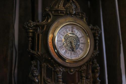 an ornate clock is sitting on a wall at Hotell Marieberg in Kristinehamn