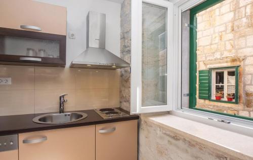 a kitchen with a sink and a window at M.A.S. in Supetar