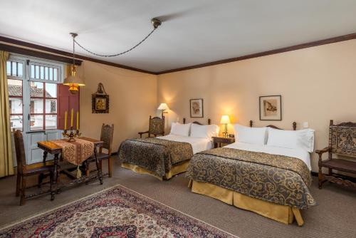 Säng eller sängar i ett rum på Hotel Dann Monasterio