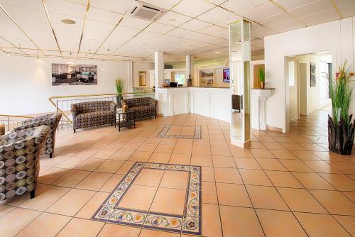 a lobby with couches and a bar in a hospital at ACHAT Hotel Bad Dürkheim in Bad Dürkheim