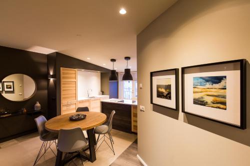 a kitchen and dining room with a table and chairs at Acco Luxury Apartments in Akureyri