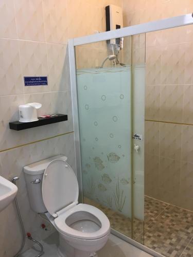 a bathroom with a toilet and a glass shower at BanKhun in Nakhon Ratchasima