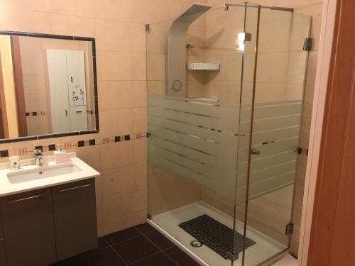 a bathroom with a shower and a sink at Apartamento T3 AL-GHARB in Armação de Pêra