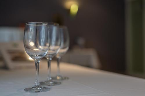 a row of wine glasses sitting on a table at ibis Styles Luzern in Luzern
