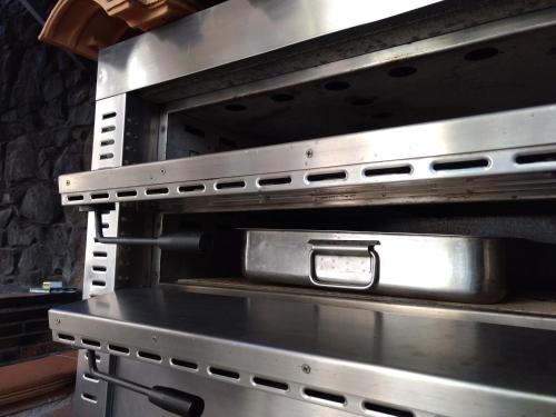 a stainless steel oven with its doors open at El Mirador De Ruidera in Ruidera