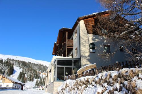 a building on a ski slope with snow on the ground at Alpengasthof Tanzstatt in Lachtal