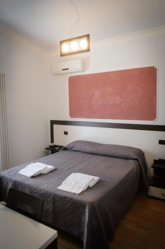 a bedroom with a bed with two towels on it at B&B Le Gemme in Castel Lagopesole