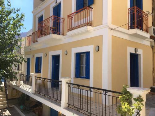 a building with blue doors and balconies on it at Anastasia Hotel in Symi