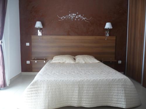 1 dormitorio con 1 cama grande y cabecero de madera en Luna verde, en Porto Vecchio