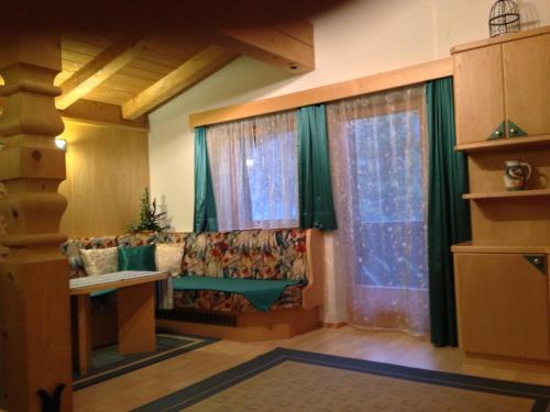 a living room with a couch and a window at Ferienapart Bergstille in Längenfeld