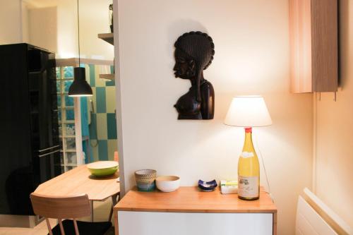 a room with a table with a lamp on it at Apartment Boulevard Brune in Paris