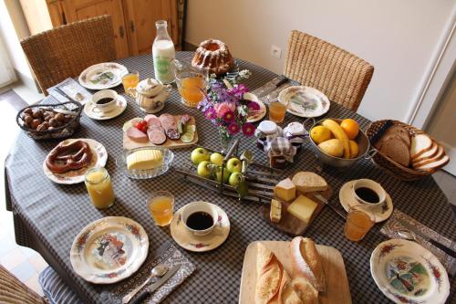 a table with breakfast foods and drinks on it at La Chambre de Marie in Bouxwiller