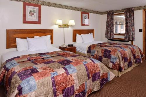 a hotel room with two beds and a window at Red Carpet Inn Ronks in Ronks