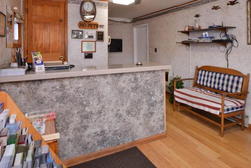 a kitchen with a counter and a bench in a room at Red Carpet Inn Ronks in Ronks