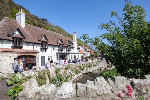 a group of people standing in front of a building at Lulworth Lodge in Lulworth Cove