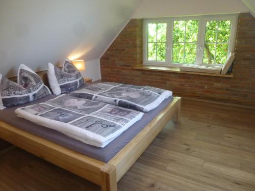 ein großes Bett in einem Zimmer mit zwei Fenstern in der Unterkunft Ferienhaus Gründl in Leibnitz