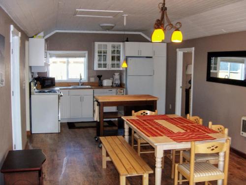 a kitchen and dining room with a table and chairs at Historic 1920s Cabin in Long Beach