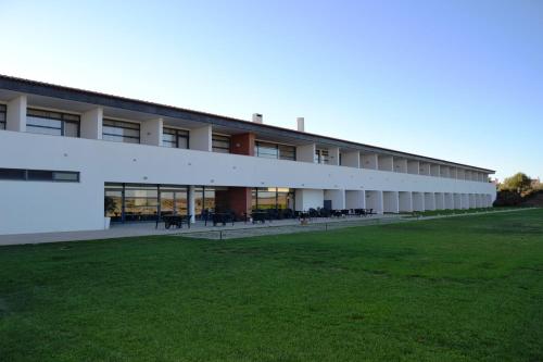 an external view of a building with a green field at Hotel Rural Santo Antonio in Arronches