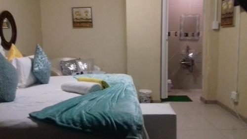 a room with a bed with pillows on it at Dudsk Bed & Breakfast in Newcastle