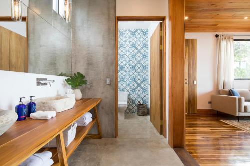 a bathroom with a wooden floor and a large window at Hotel Belmar in Monteverde Costa Rica