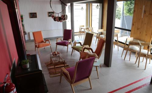 a room with a bunch of chairs and a table at Hotel Ilaia in Punta Arenas