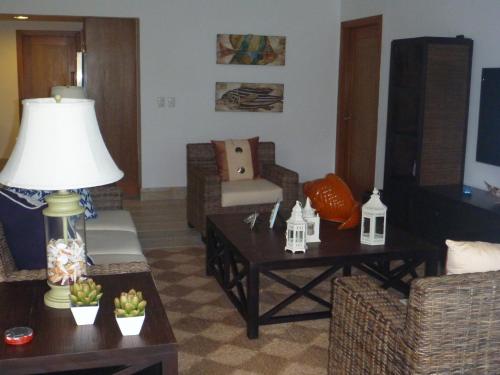 a living room with a couch and a table at Your Second Home Away in Las Terrenas