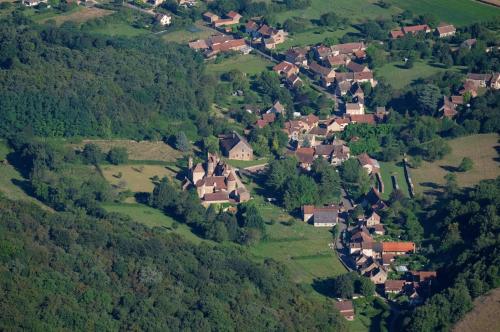 an aerial view of a small village on a hill at Chateau de Balleure in Étrigny