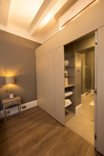 a room with a closet with a table and a desk at Merchants Street Valletta Apartment in Valletta
