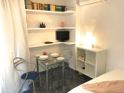 ベナルマデナにあるSea View Apartmentの小さなテーブル(椅子2脚付)、テレビが備わります。