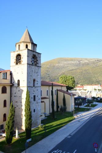 a building with a clock tower on the side of a road at L'Appoggio in Fondi