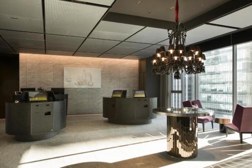 a lobby with a chandelier and a table and chairs at L7 GANGNAM by LOTTE in Seoul