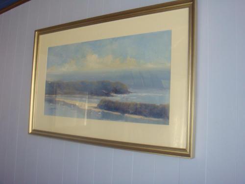 a picture of a painting hanging on a wall at Kingfisher Motel (Adults only) in Merimbula