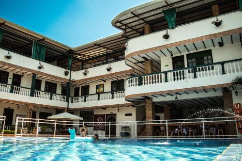 a pool at a hotel with a pool noodle in the water at Hotel El Virrey Boutique Honda in Honda