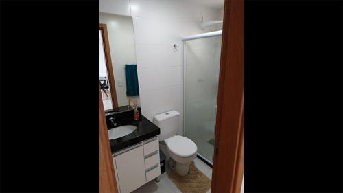 Un baño con inodoro, lavabo y ducha. en Le Bon Vivant 307 B, en Arraial do Cabo