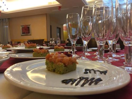 a table with plates of food and wine glasses at La Buona Forchetta - S. Anna in San Giovanni Rotondo