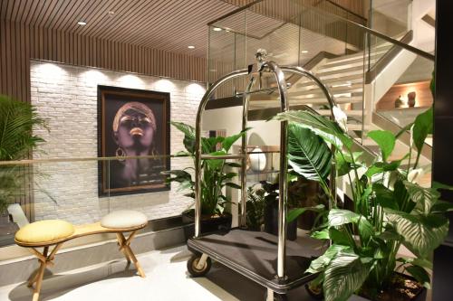 a bathroom with plants and a shower with a monkey on the wall at Hotel Panoramika Design & Spa in Skopje