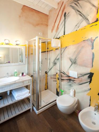 a bathroom with a shower and a toilet and a sink at Locanda Cece e Simo in Bergamo