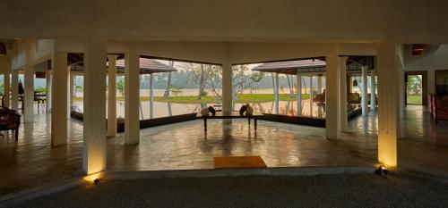 a large building with a lobby with a view of the water at Cranganor History Café & Riverside Château in Parūr