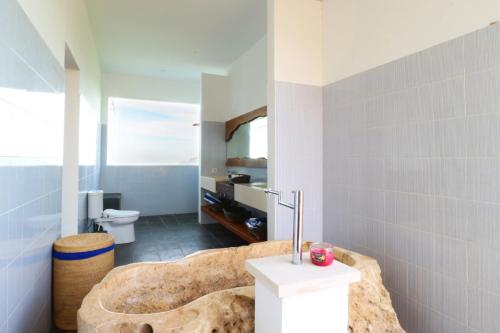 a bathroom with a large animal shaped tub in a room at Villa Nambung in Selong Belanak