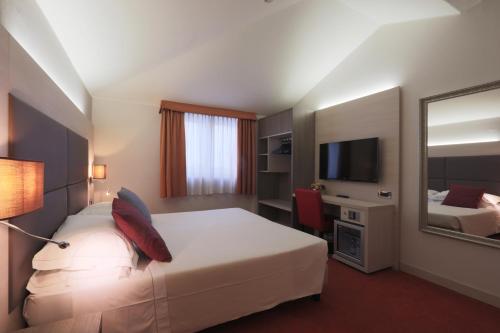 En eller flere senge i et værelse på Hotel Campion
