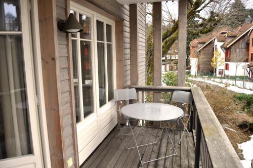 a porch with a white table and chairs on it at StrandBerg's Designhotel Viktoria in Braunlage