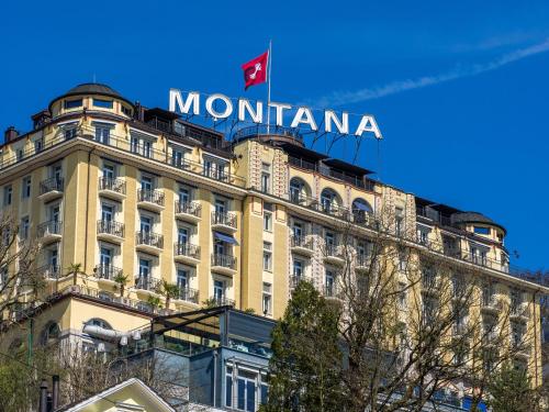 a building with a sign on top of it at Art Deco Hotel Montana Luzern in Luzern