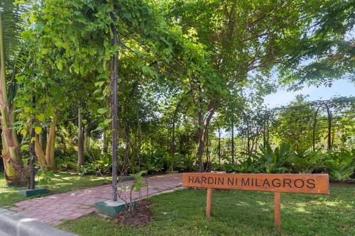 a sign in a park with a sign in the grass at Kandaya Resort in Daanbantayan