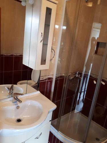 a bathroom with a sink and a shower at Seaside apartment for 2 p in Trogir