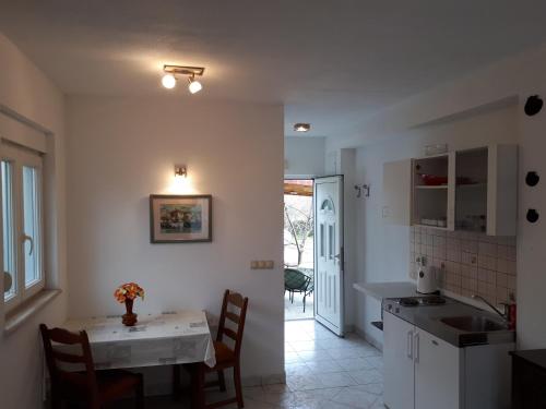 a kitchen and dining room with a table and chairs at Seaside apartment for 2 p in Trogir