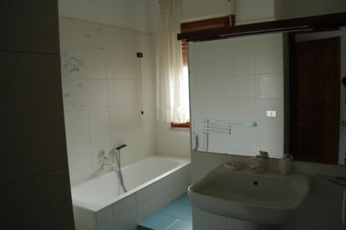 a white bathroom with a tub and a sink at Villa Peppe B&B in Francavilla al Mare