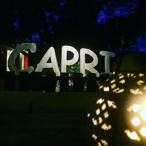 a sign that reads apr in the dark at Hostal Capri in Es Pujols