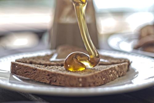 a spoon of peanut butter on a piece of bread at Brazzera Hotel in Finikas