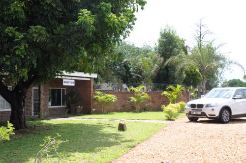 a white car parked in front of a house at Casa Leitao Lodge in Phalaborwa