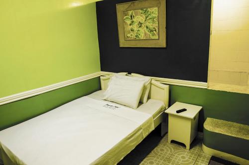 a small room with a small bed and a table at Dreamwave Resort Pansol Laguna in Calamba